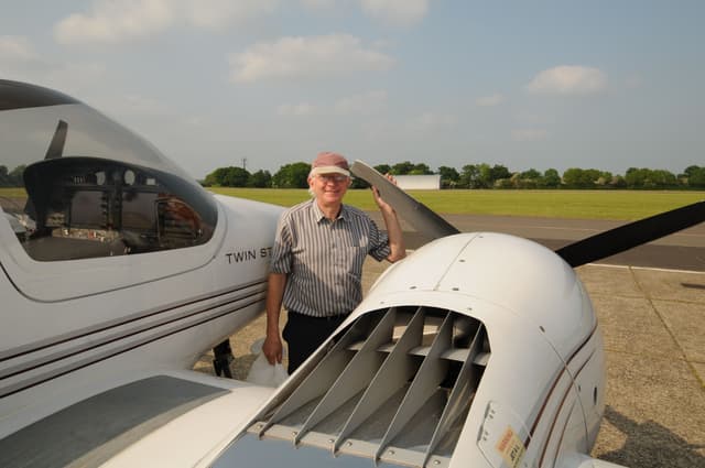 Owen Rosindell standing next to a twin-engine aircraft